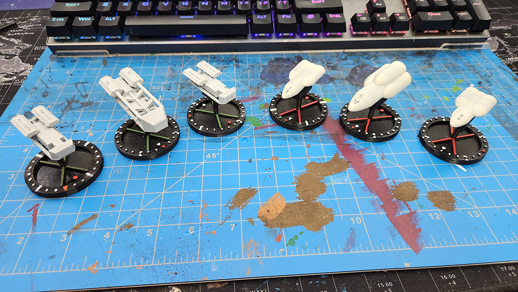 Spaceships and widgets - porotype game pieces.